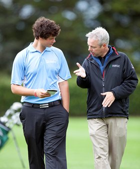 A student receives golf coaching at the University